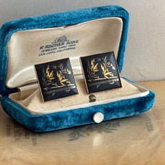 Vintage Amita Japan damascene square cufflinks with gold and silver bamboo motif on black enamel, signed on the back, displayed on a neutral surface.