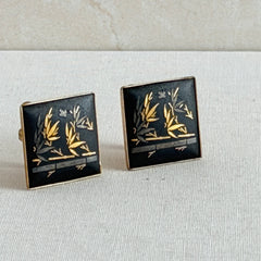 Vintage Amita Japan damascene square cufflinks with gold and silver bamboo motif on black enamel, signed on the back, displayed on a neutral surface.