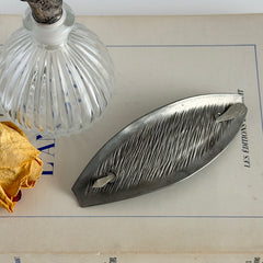Vintage Danish S.I.D. pewter hair barrette with textured diagonal surface and signed back, elongated oval shape, 1970s–80s Scandinavian design.