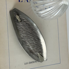 Vintage Danish S.I.D. pewter hair barrette with textured diagonal surface and signed back, elongated oval shape, 1970s–80s Scandinavian design.