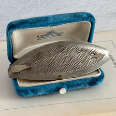 Vintage Danish S.I.D. pewter hair barrette with textured diagonal surface and signed back, elongated oval shape, 1970s–80s Scandinavian design.