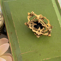 Vintage gold‑tone Victorian Revival brooch with red faceted glass cabochon and faux pearls.