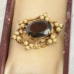 Vintage gold‑tone Victorian Revival brooch with red faceted glass cabochon and faux pearls.