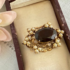 Vintage gold‑tone Victorian Revival brooch with red faceted glass cabochon and faux pearls.