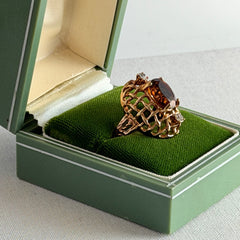 Vintage gold plated ring with an oval dark‑topaz CZ center stone and two clear rhinestone accents.