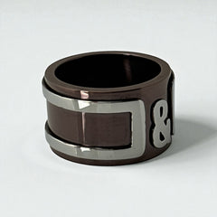 Dolce & Gabbana men's stainless steel ring with brown finish and raised silver-tone logo; bold designer accessory in size 8.5 with wide band styling.