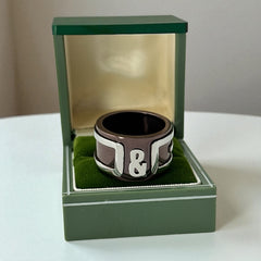Dolce & Gabbana men's stainless steel ring with brown finish and raised silver-tone logo; bold designer accessory in size 8.5 with wide band styling.