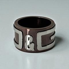 Dolce & Gabbana men's stainless steel ring with brown finish and raised silver-tone logo; bold designer accessory in size 8.5 with wide band styling.