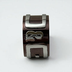 Dolce & Gabbana men's stainless steel ring with brown finish and raised silver-tone logo; bold designer accessory in size 8.5 with wide band styling.