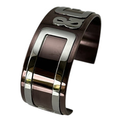 Dolce & Gabbana men's stainless steel cuff bracelet with a brown finish and raised silver-tone logo plaque; modern designer accessory with bold branding and sculptural detail.