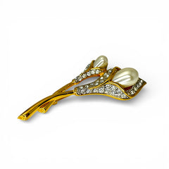 Vintage Edith Vanderbilt gold‑tone arum flowers brooch featuring two sculptural blooms with faux pearls and clear pave rhinestones, shown in various styled settings to highlight its elegant curves and luminous detail.