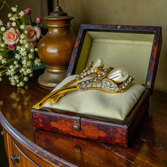 Vintage Edith Vanderbilt gold‑tone arum flowers brooch featuring two sculptural blooms with faux pearls and clear pave rhinestones, shown in various styled settings to highlight its elegant curves and luminous detail.