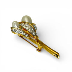 Vintage Edith Vanderbilt gold‑tone arum flowers brooch featuring two sculptural blooms with faux pearls and clear pave rhinestones, shown in various styled settings to highlight its elegant curves and luminous detail.