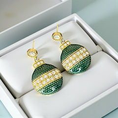 Vintage Eisenberg Ice Christmas ornament earrings with green enamel, clear rhinestone band, and gold-tone stud; signed and festive dangle design.