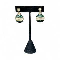 Vintage Eisenberg Ice Christmas ornament earrings with green enamel, clear rhinestone band, and gold-tone stud; signed and festive dangle design.