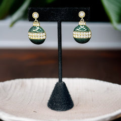 Vintage Eisenberg Ice Christmas ornament earrings with green enamel, clear rhinestone band, and gold-tone stud; signed and festive dangle design.