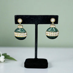 Vintage Eisenberg Ice Christmas ornament earrings with green enamel, clear rhinestone band, and gold-tone stud; signed and festive dangle design.