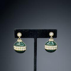 Vintage Eisenberg Ice Christmas ornament earrings with green enamel, clear rhinestone band, and gold-tone stud; signed and festive dangle design.