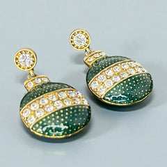 Vintage Eisenberg Ice Christmas ornament earrings with green enamel, clear rhinestone band, and gold-tone stud; signed and festive dangle design.