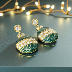 Vintage Eisenberg Ice Christmas ornament earrings with green enamel, clear rhinestone band, and gold-tone stud; signed and festive dangle design.