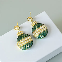 Vintage Eisenberg Ice Christmas ornament earrings with green enamel, clear rhinestone band, and gold-tone stud; signed and festive dangle design.