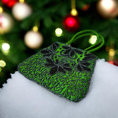Vintage 1990s emerald green satin evening bag with handsewn black and hematite glass bead floral motifs, dual green handles, and optional crossbody cord, photographed to show craftsmanship, texture, and convertible styling.