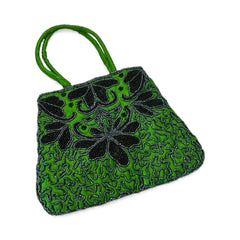 Vintage 1990s emerald green satin evening bag with handsewn black and hematite glass bead floral motifs, dual green handles, and optional crossbody cord, photographed to show craftsmanship, texture, and convertible styling.