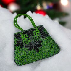 Vintage 1990s emerald green satin evening bag with handsewn black and hematite glass bead floral motifs, dual green handles, and optional crossbody cord, photographed to show craftsmanship, texture, and convertible styling.