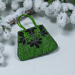 Vintage 1990s emerald green satin evening bag with handsewn black and hematite glass bead floral motifs, dual green handles, and optional crossbody cord, photographed to show craftsmanship, texture, and convertible styling.