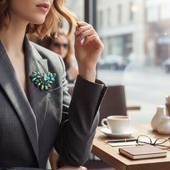 Vintage 1950s brooch featuring layered AB emerald rhinestones in marquise and chaton cuts, set in silver tone metal with a central dog tooth prong setting; photographed to highlight sparkle, craftsmanship, and mid-century design.