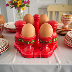 Vintage Emsa West Germany red plastic kitchen set with green flower pattern, featuring salt and pepper shakers, egg cups, and tray.