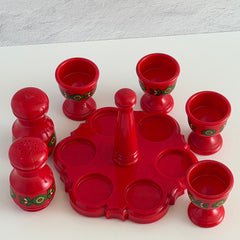 Vintage Emsa West Germany red plastic kitchen set with green flower pattern, featuring salt and pepper shakers, egg cups, and tray.