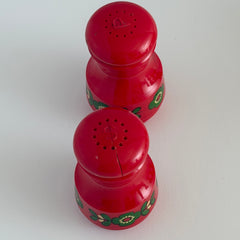 Vintage Emsa West Germany red plastic kitchen set with green flower pattern, featuring salt and pepper shakers, egg cups, and tray.