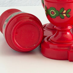 Vintage Emsa West Germany red plastic kitchen set with green flower pattern, featuring salt and pepper shakers, egg cups, and tray.