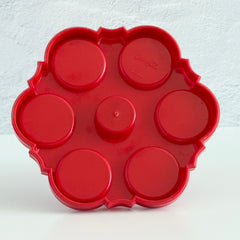 Vintage Emsa West Germany red plastic kitchen set with green flower pattern, featuring salt and pepper shakers, egg cups, and tray.