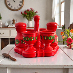 Vintage Emsa West Germany red plastic kitchen set with green flower pattern, featuring salt and pepper shakers, egg cups, and tray.