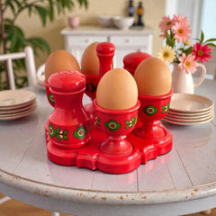 Vintage Emsa West Germany red plastic kitchen set with green flower pattern, featuring salt and pepper shakers, egg cups, and tray.