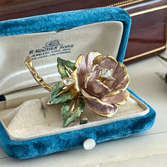 Vintage 1997 Graziano ‘England’s Rose’ brooch with light pink enamel‑painted petals, light green enamel‑painted leaves, clear rhinestones, and a gold‑tone stem, signed on the back.