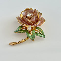 Vintage 1997 Graziano ‘England’s Rose’ brooch with light pink enamel‑painted petals, light green enamel‑painted leaves, clear rhinestones, and a gold‑tone stem, signed on the back.
