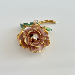 Vintage 1997 Graziano ‘England’s Rose’ brooch with light pink enamel‑painted petals, light green enamel‑painted leaves, clear rhinestones, and a gold‑tone stem, signed on the back.