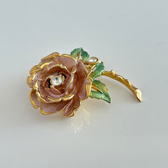 Vintage 1997 Graziano ‘England’s Rose’ brooch with light pink enamel‑painted petals, light green enamel‑painted leaves, clear rhinestones, and a gold‑tone stem, signed on the back.
