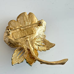 Vintage 1997 Graziano ‘England’s Rose’ brooch with light pink enamel‑painted petals, light green enamel‑painted leaves, clear rhinestones, and a gold‑tone stem, signed on the back.