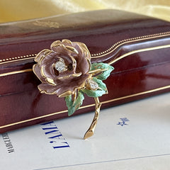 Vintage 1997 Graziano ‘England’s Rose’ brooch with light pink enamel‑painted petals, light green enamel‑painted leaves, clear rhinestones, and a gold‑tone stem, signed on the back.