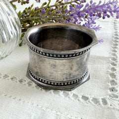 Antique silver‑plated napkin ring with beaded borders and engraved E.L.A. No. 3.