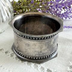 Antique silver‑plated napkin ring with beaded borders and engraved E.L.A. No. 3.