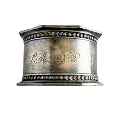 Antique silver‑plated napkin ring with beaded borders and engraved E.L.A. No. 3.
