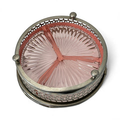 Vintage Farberware relish dish featuring pink Depression glass in a divided three-section design, set in a silver-tone openwork metal basket with arched handle and pedestal base; photographed in soft light to highlight its rosy hue and Art Deco detailing.