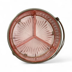 Vintage Farberware relish dish featuring pink Depression glass in a divided three-section design, set in a silver-tone openwork metal basket with arched handle and pedestal base; photographed in soft light to highlight its rosy hue and Art Deco detailing.