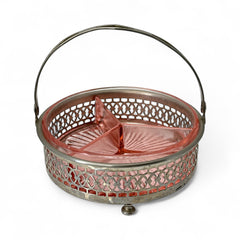 Vintage Farberware relish dish featuring pink Depression glass in a divided three-section design, set in a silver-tone openwork metal basket with arched handle and pedestal base; photographed in soft light to highlight its rosy hue and Art Deco detailing.