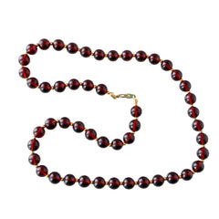 Vintage cherry amber acrylic bead necklace with gold tone spacers and clasp displayed on neutral background.